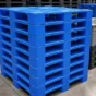 Stack of blue plastic pallets used for warehouse storage and material handling